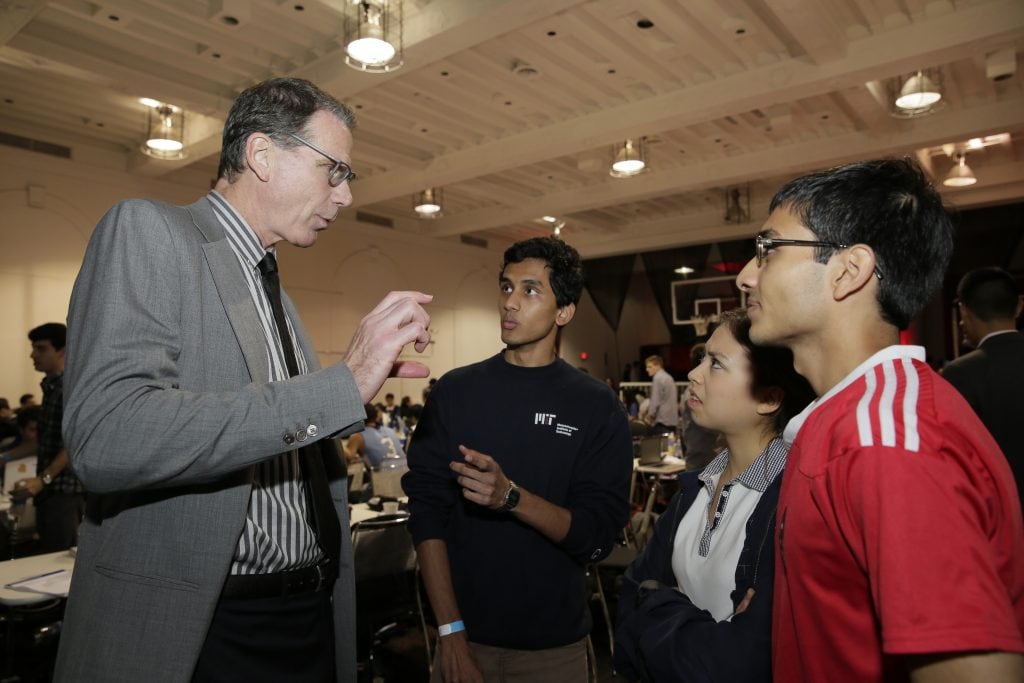 Kiki VanDeWeghe talks with competitors about their project before they present to the judging panel.
